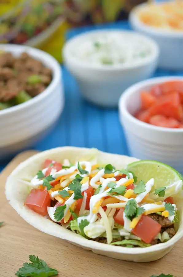 Turkey Taco Boats-Spice up your next Cinco De Mayo with these delicious Turkey Taco Bowls. Flavorful, ground turkey combines perfectly with an edible Old El Paso Flour Tortilla Taco Boat.